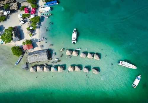 created by dji camera aerial view of beach huts sitting on a sandbar in crystal clear waters off the coast of cartagena colombia